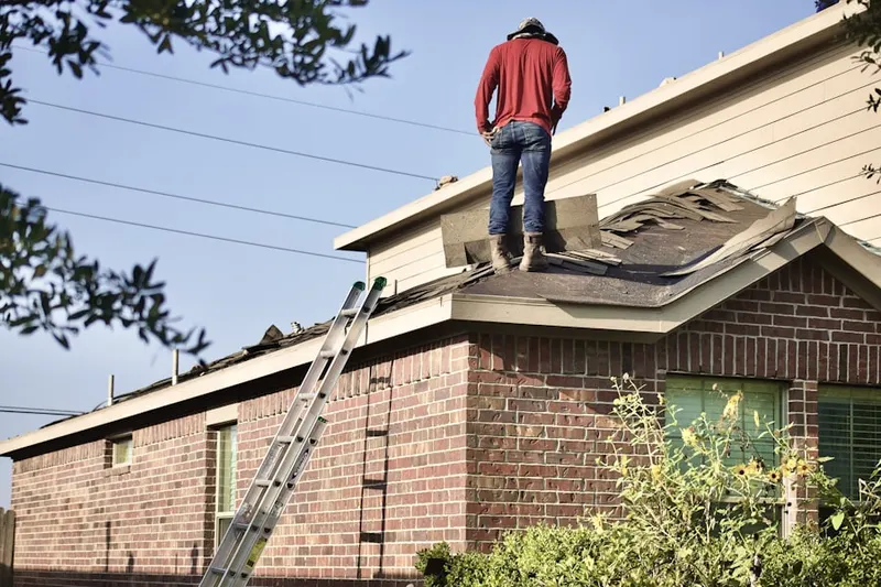 Professional roofer working on a residential roof in Waverly Way